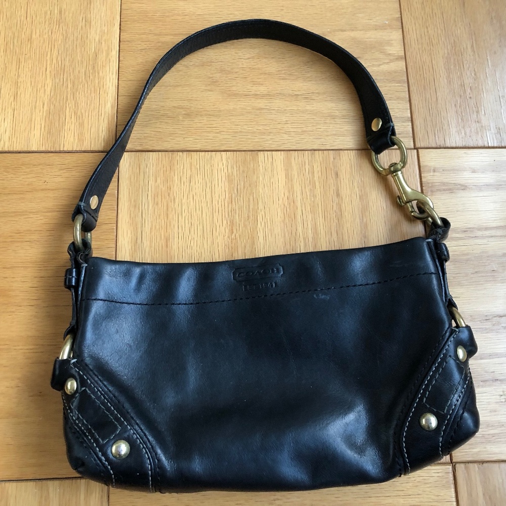 Coach leather bag with metal details.